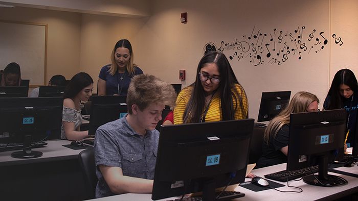 Students completed registration of high school in 2020 sitting in a class. 