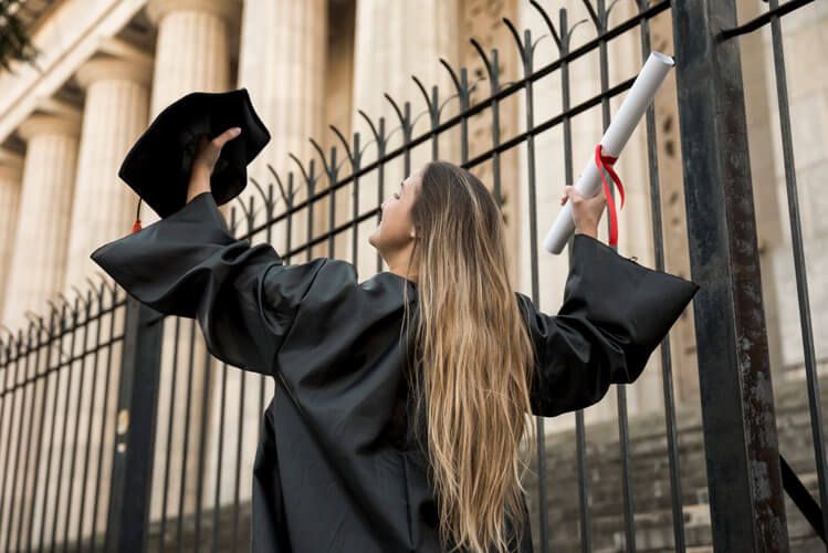 a girl with her degree in hand after she completed her graduation