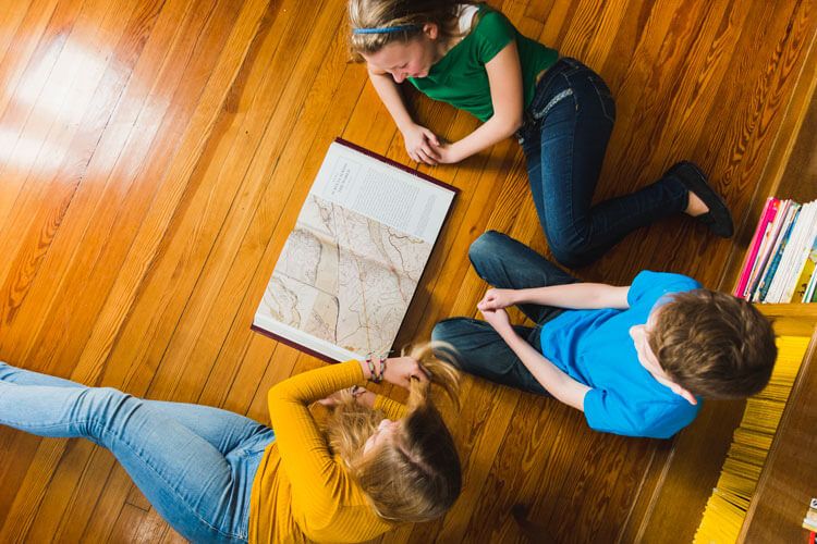 a group of students studying a book together