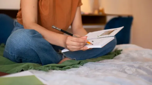 Side view woman doing creative journaling