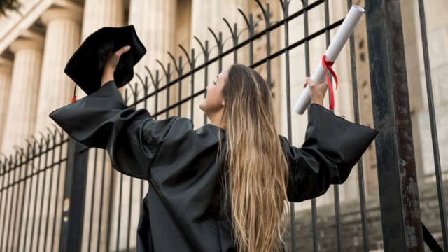 a girl with her degree in hand after she completed her graduation
